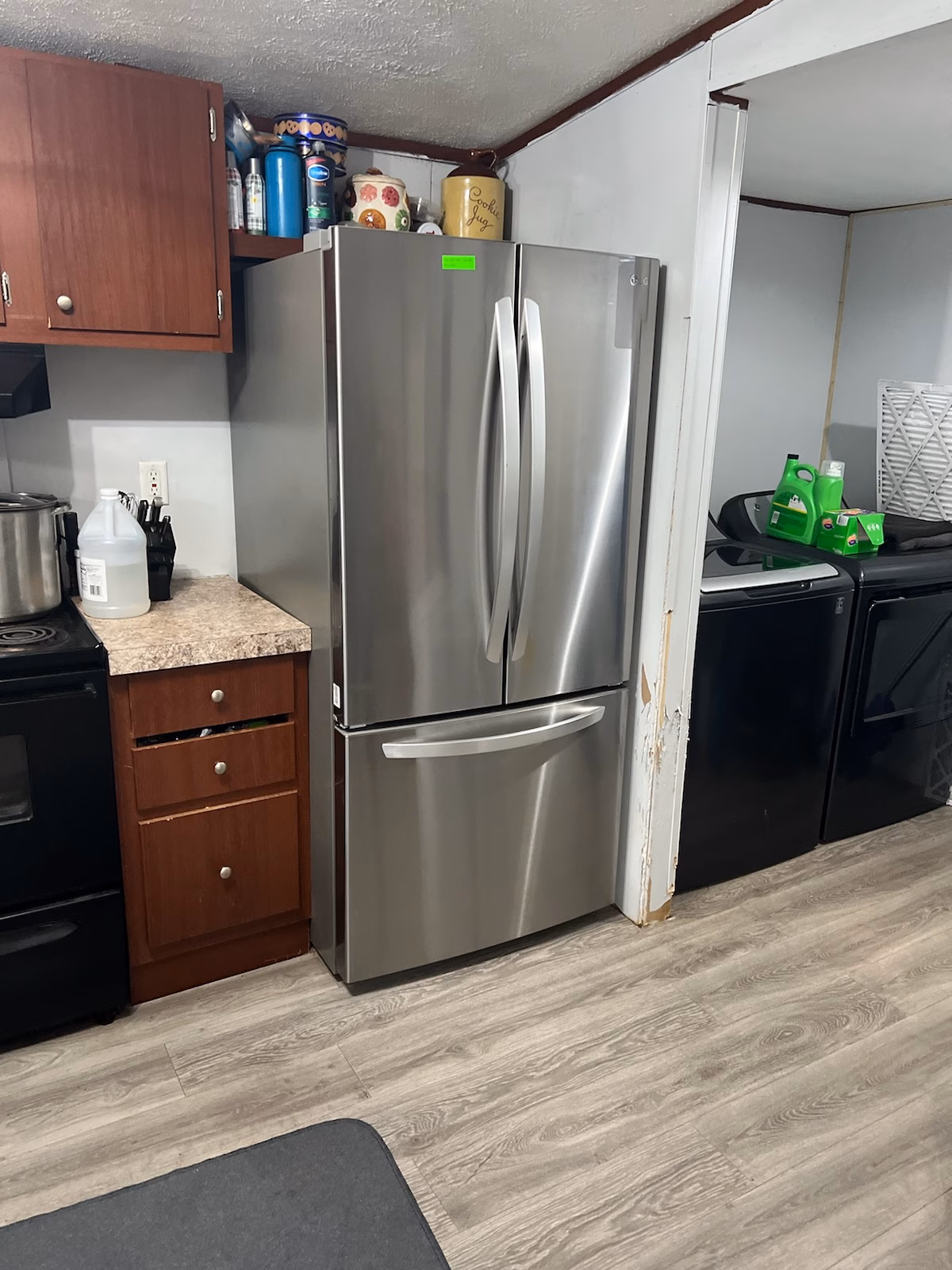 Stainless French-door refrigerator installed in a galley kitchen