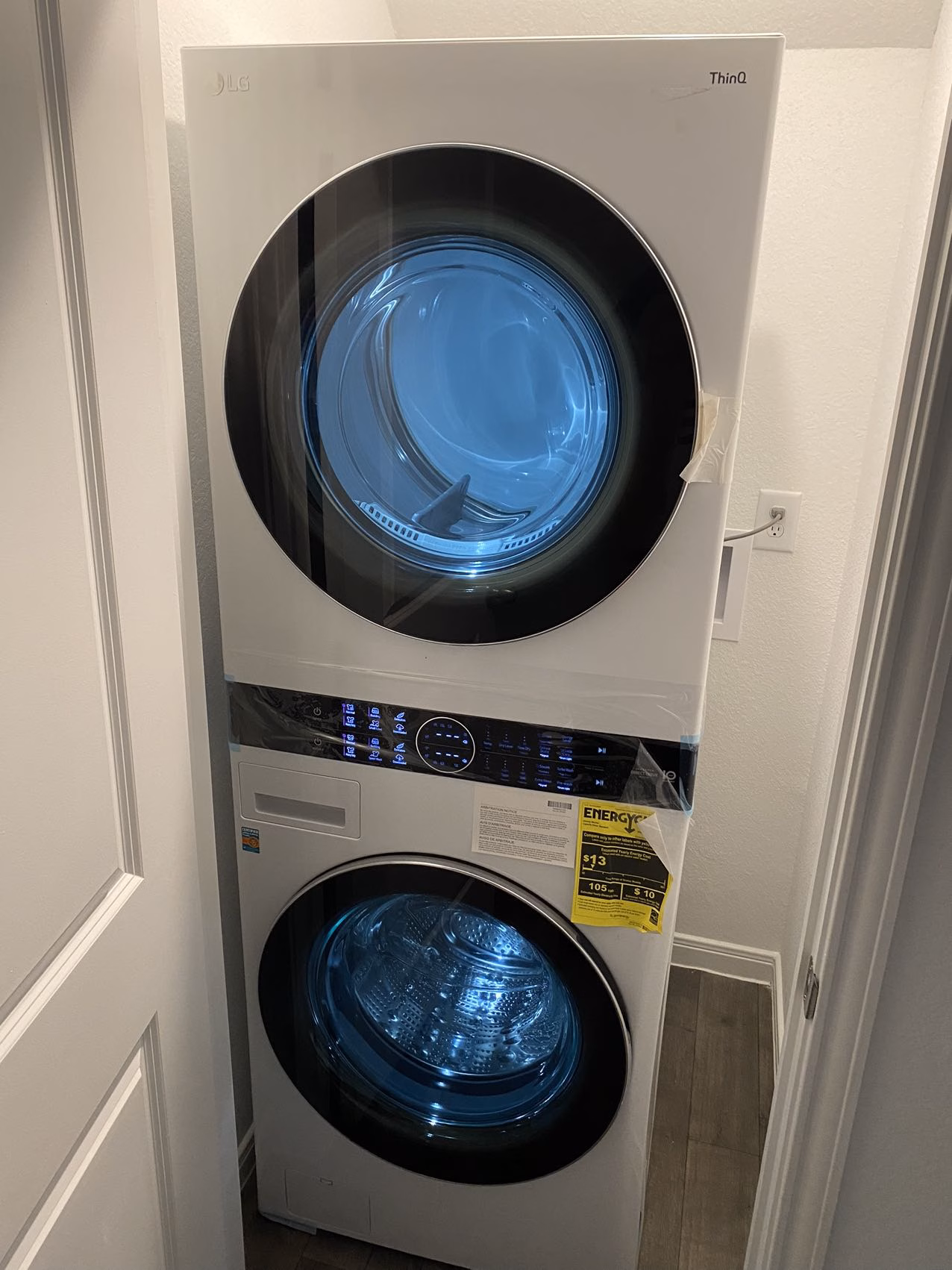 White LG WashTower installed in a narrow laundry alcove
